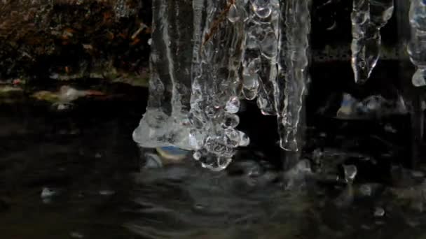 Ice icicles on a freezing fountain in winter — Stock Video