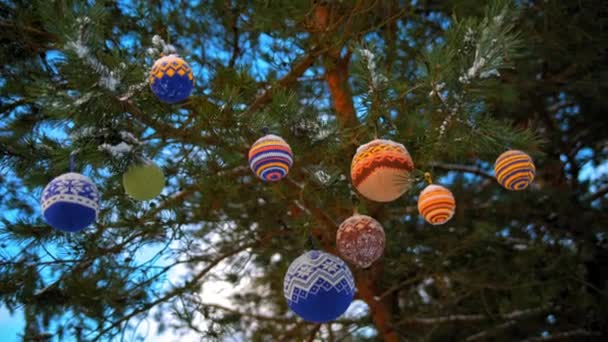 Bolas de Natal penduradas em ramos de pinho cobertos de neve — Vídeo de Stock