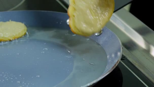 Potato pancakes are fried in a pan — Stock Video