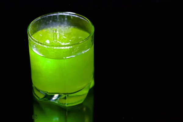 Cocktail verde in un bicchiere su sfondo nero — Foto Stock