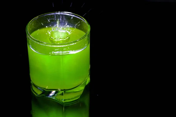 Green cocktail in a glass on black background — Stock Photo, Image