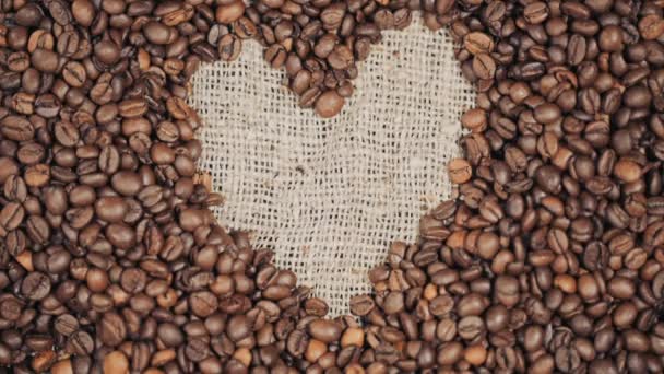Kávová zrna na dřevěný stůl. Srdce z kávových zrn