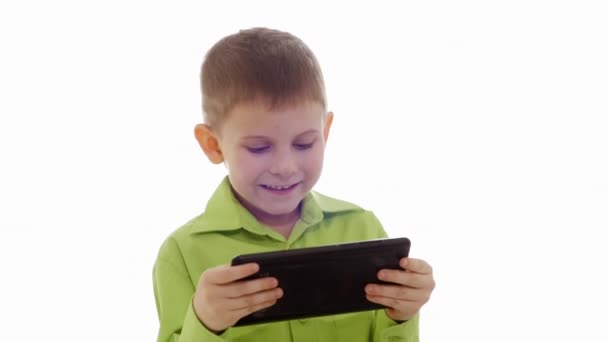 A boy plays on the tablet. Slow motion — Stock Video