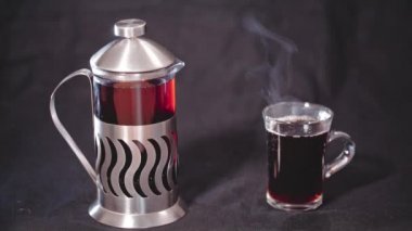 Fransız basın çay ve şeffaf bir fincan çay siyah bir arka plan ile