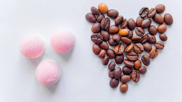 Pink candy and heart from coffee beans on white background — Stock Photo, Image