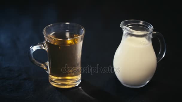 A Cup of green tea and a jug of milk — Stock Video