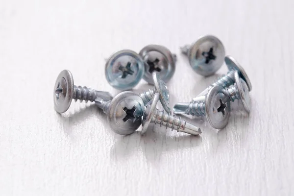 Self-tapping screws on a light background — Stock Photo, Image