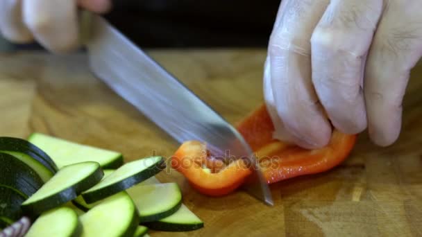 The chef slices bell pepper. Slow motion — Stock Video