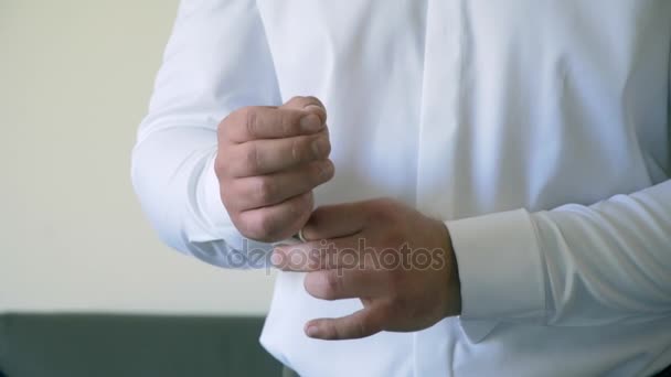 Man buttons cuff link on the shirt — Stock Video