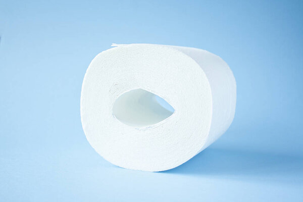 Туалетная бумага рулон на синем фоне вид сверху. Покупка туалетной бумаги из-за концепции кронавируса. Личная гигиена и прекращение распространения вируса. Чистота, гигиена, стерильность

