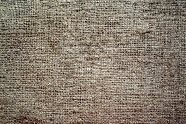 Aged vintage and weathered cloth background texture. Old damaged brown rough texture