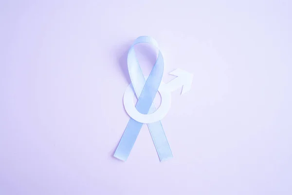 Prostate cancer awareness blue ribbon with white paper male sign mars arrow on pink background. Men healthcare concept, men carcinoma symbol.