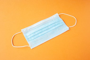 Turuncu sırt grubunda bakteri ve virüslere karşı tek kullanımlık tıbbi maske. Koronavirüsün yayılmasını engelle, nefsi müdafaa. Boşluğu kopyala