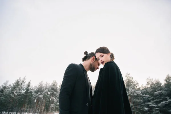 Unusual wedding couple in the forest in winter — Stock Photo, Image