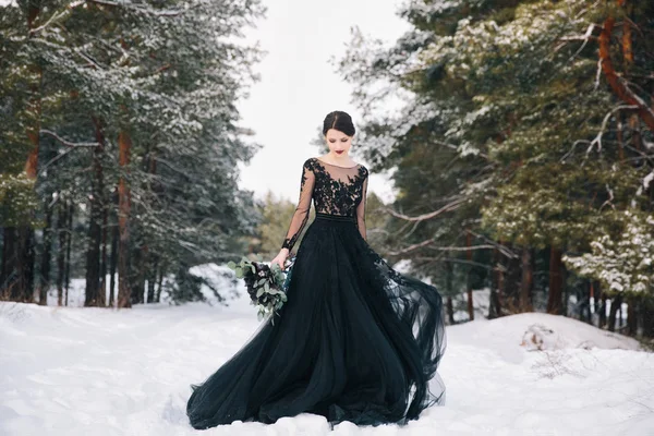 A téli erdő egy fekete ruhás menyasszony — Stock Fotó