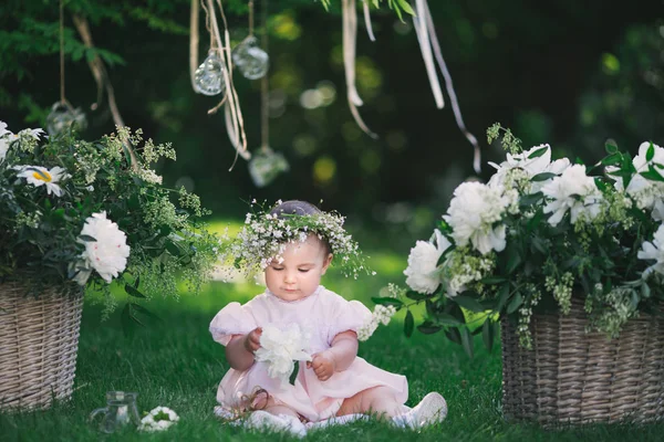 Girl playing on the lawn with flowers — Stock Photo, Image