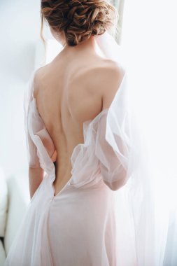 Portrait of the bride with open dress from the back. Open back. Beautiful neckline on the dress. sexy back clipart