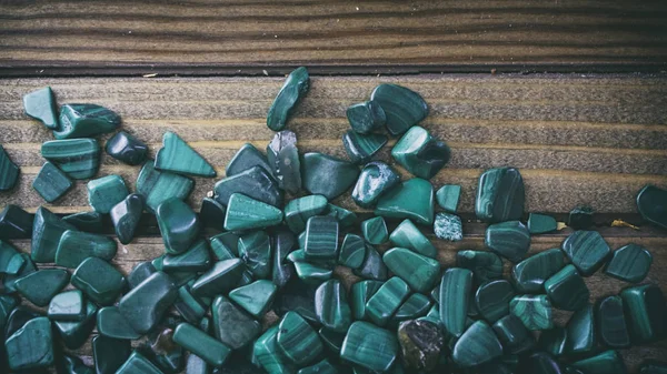 Malaquita sobre fondo de madera, pequeñas conchas sobre fondo de madera — Foto de Stock