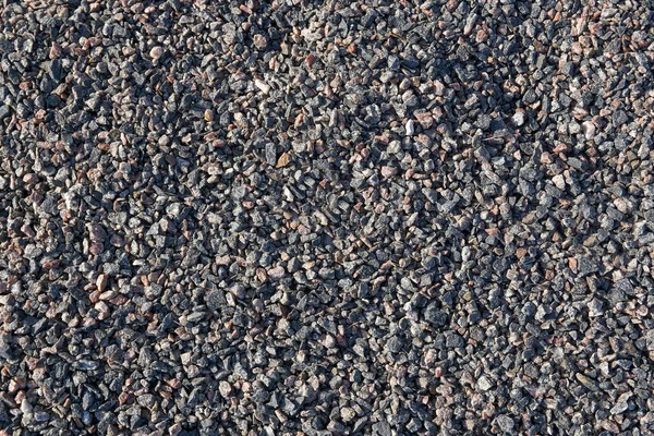 Fine crushed granite. The stone is gray with a splash of pink an