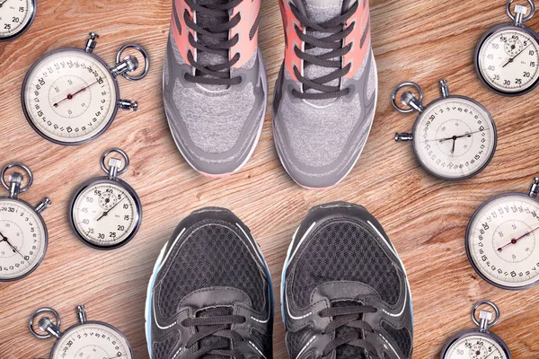 Running equipment. Stopwatch and running shoes. Time for run. Sport running accessories on the wooden floor. Sports rivalry.Together running is cool.