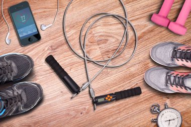 Eğitim spor salonu fitness whit-ip atlama. Jimnastik ve ahşap zemin zemin üzerine eğitim donanımları. Koşu ayakkabıları ve egzersiz. Stopwach katiyen nabız smartphone ve müzik çalar.