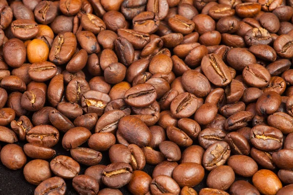 Coffee beans scattered on the table. Texture from grains of black coffee. Wall Mural scattered coffee.