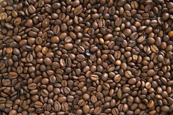 Coffee beans scattered on the table. Texture from grains of black coffee. Wall Mural scattered coffee.