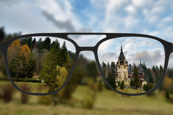 Clear image in glasses against blurry landscape