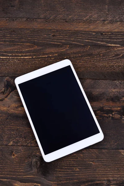 Weißes digitales Tablet mit schwarzem Bildschirm auf Holztisch — Stockfoto