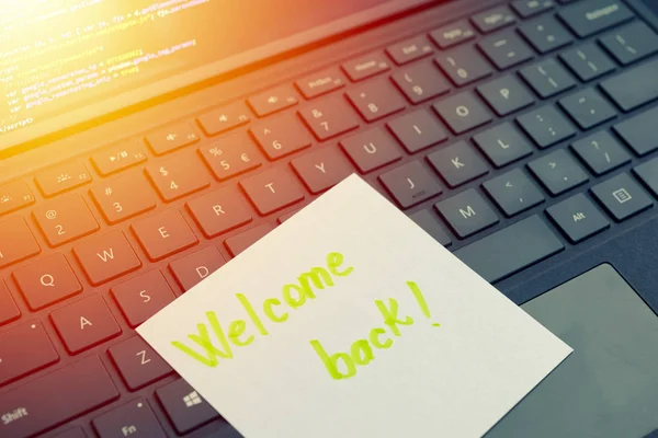 Welcome back message concept written post it on laptop keyboard