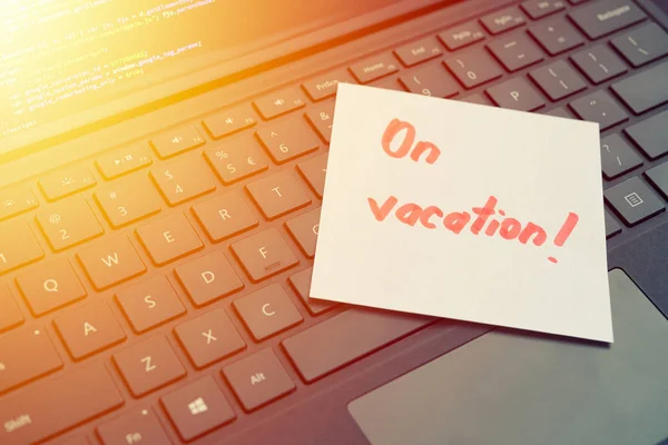 On vacantion message concept written post it on laptop keyboard