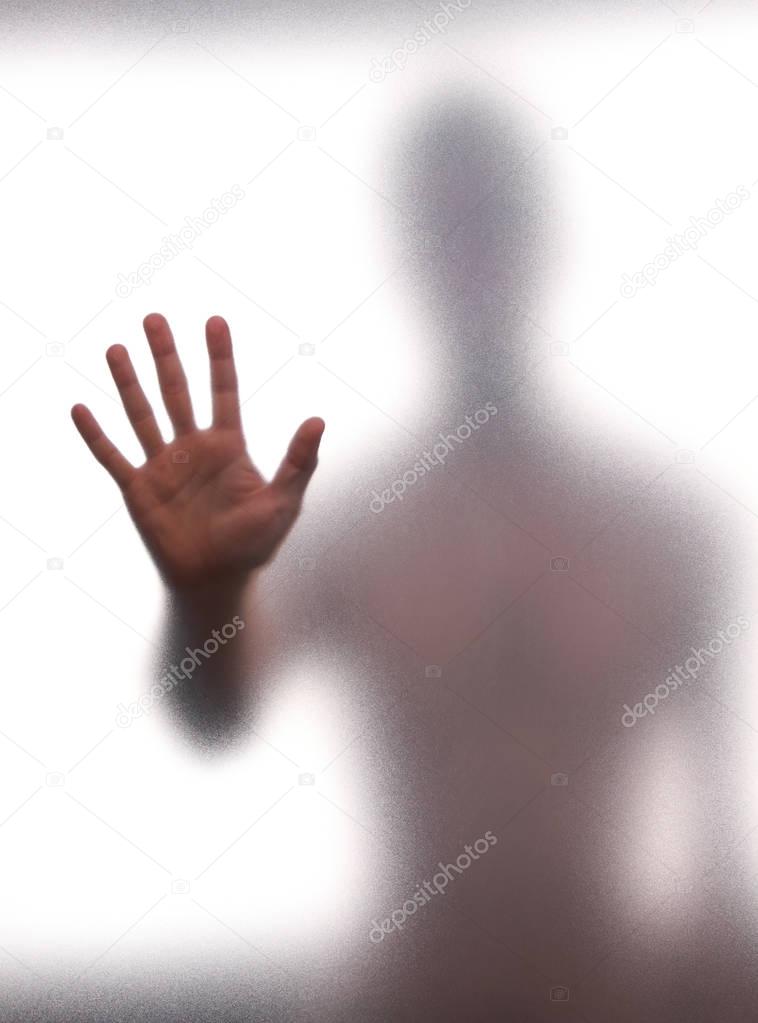 Mystic silhouette of man against the transparent wall