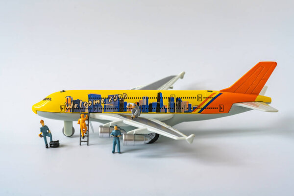 Close up miniature airplane and technicians maintenance and chec