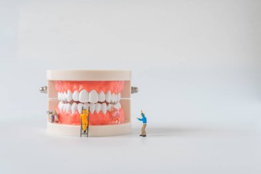 Minyatür işçi arabadaki motoru tamir etti ve kontrol etti. Bakım servisi konsepti.