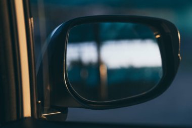 Close-up car side mirror with blurred background