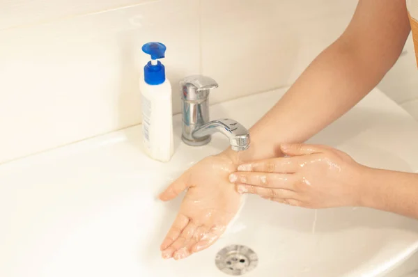 Step 7: Wash off the rest of the foam and soap with warm water. To prevent a coronavirus pandemic, wash your hands thoroughly with warm water and an antibacterial soap. World pandemic concept.