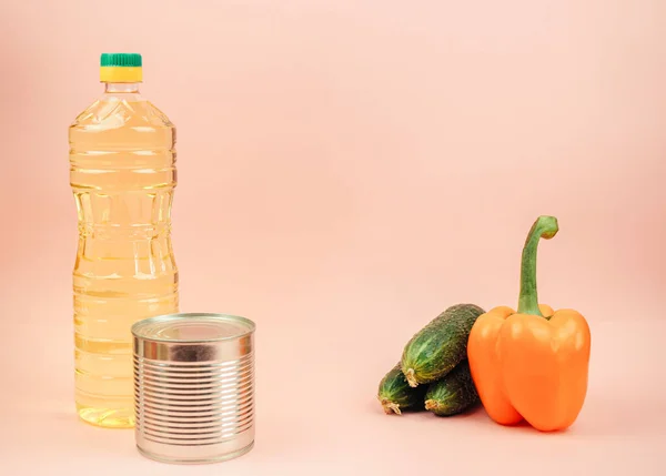 Food supply quarantine food crisis isolated on pink background. pasta, canned food, cucumbers, butter, sweet pepper. The concept of food delivery, donation, charity. Copyspace.