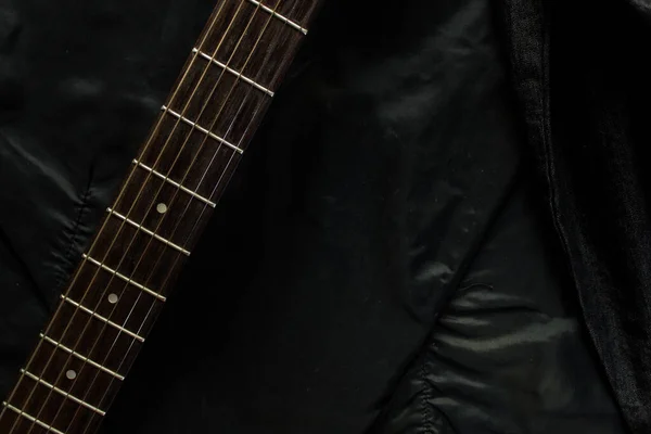 Acoustic guitar with a denim jacket — Stock Photo, Image