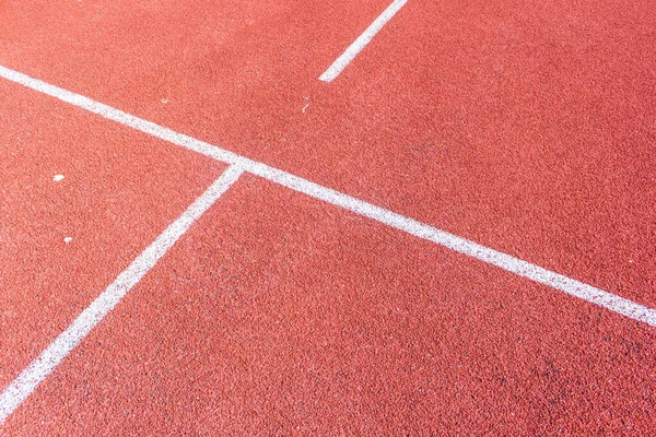 Running track with white line texture.