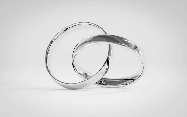 Серебряные обручальные кольца на белом фоне — стоковое фото