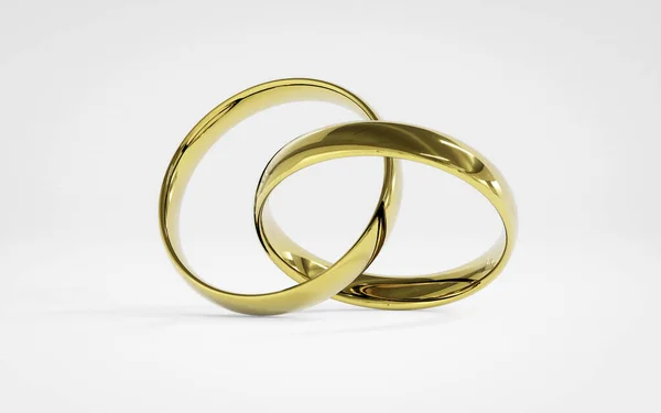 Золотые обручальные кольца на белом фоне — стоковое фото