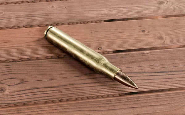 Golden bronze Rifle bullet on wooden table 3d render illustration — Stock Photo, Image