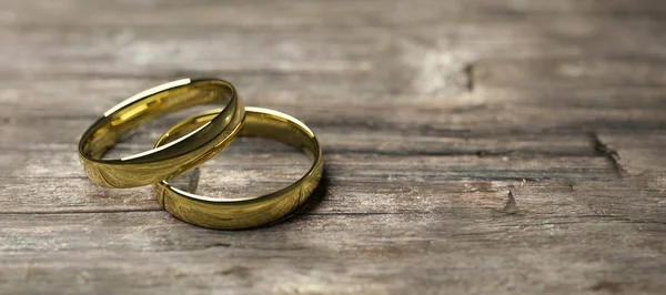 Gold wedding rings on wooden table soft focus macro shot 3d render illustration — 스톡 사진