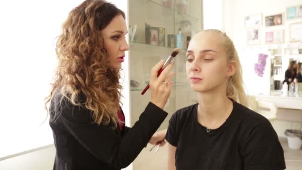 Maquiagem artista trabalha em um modelo — Vídeo de Stock
