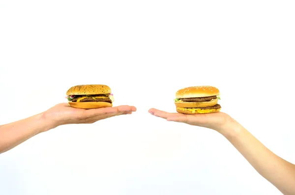 two hands are different burgers to choose from, isolated on white background.