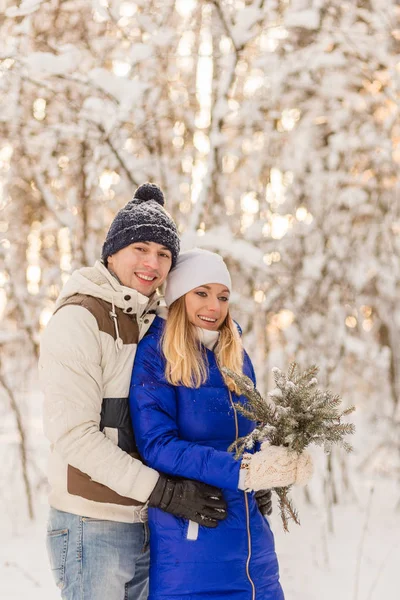 De jongen en het meisje hebben een rust in de bossen van de winter. — Stockfoto