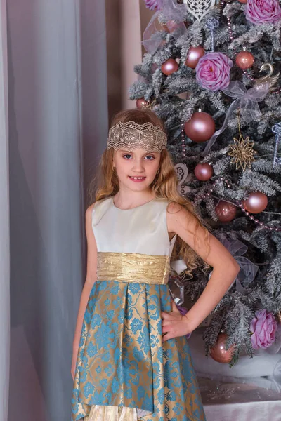 Menina bonita em um vestido de noite longo em decorações de Natal . — Fotografia de Stock