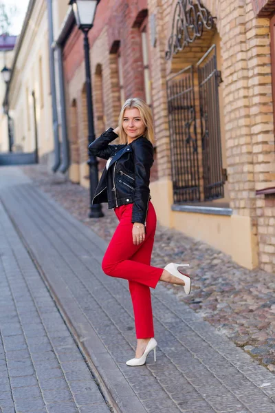 Kırmızı pantolon içinde güzel bir sarışın portresi