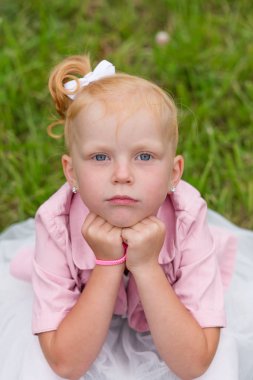 Sevimli küçük bir kız güzel bir elbise ve oynarken spor ayakkabı 