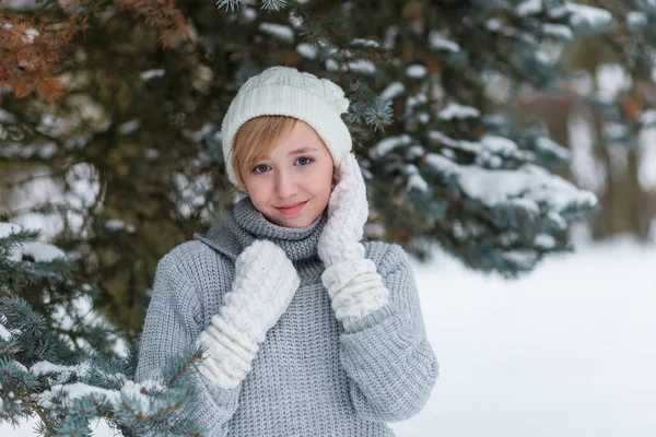 Hermosa chica en un sombrero blanco y manoplas en el invierno nevado fo — Foto de Stock